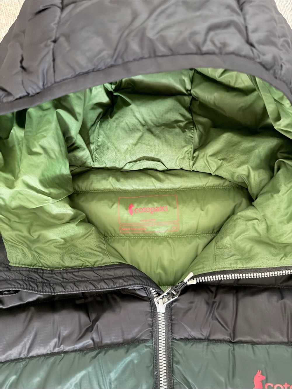 Cotopaxi Black Hooded Puffer with Green and Blue Chest Stripes - Picture 3 of 3